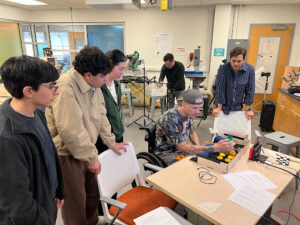 Engineering students watch as their adaptive controller is tested 