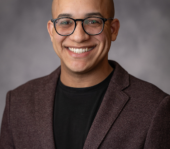 Nolgie Oquendo-Colón smiles in a professional headshot